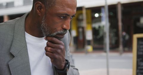 Pensive Man at Cafe Terrace Holding Cup of Coffee