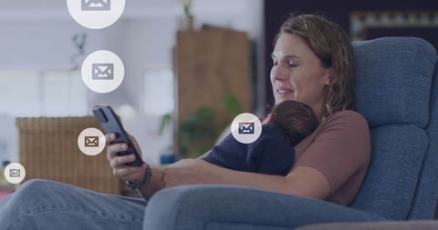Mother Multitasking with Smartphone While Holding Newborn