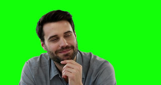 Man with beard deep in thought in front of green screen background. This image is useful for projects requiring flexibility with background removal or substitution. Suitable for presentations, advertisements, educational content, and promotional materials.