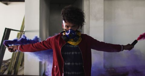 Person Holding Colorful Flares in Abandoned Urban Space