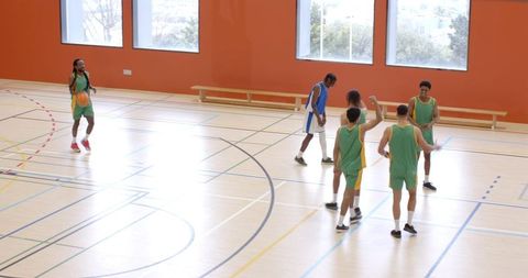 Energetic Basketball Team Training on Indoor Court