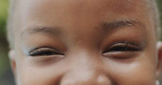 Portrait of happy eyes of african american girl in garden. Lifestyle, free time, childhood, nature, summer and domestic life, unaltered.