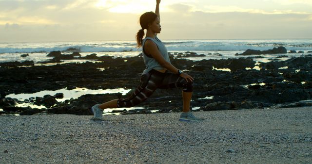 Woman Practicing Yoga Poses on Rocky Beach at Sunset - Download Free Stock Images Pikwizard.com