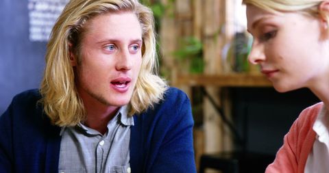 Young professionals conversing in casual cafe environment