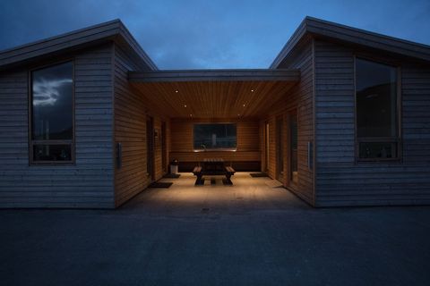Modern Wooden Cabin Lit and Vacant at Dusk