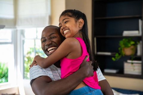 Father and Daughter Sharing a Warm Embrace at Home