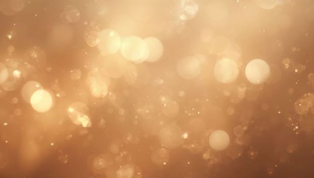 Glowing Golden Bokeh Shimmering Background with Sparkling Dust and Warm Orbs