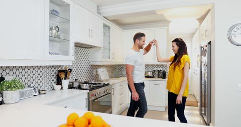 Happy Couple Dancing in Modern Bright Kitchen