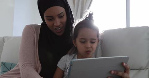 Mother and Daughter Engaging with Tablet at Home
