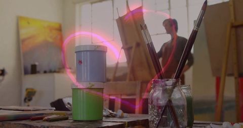 Creative art studio with paintbrushes and neon heart