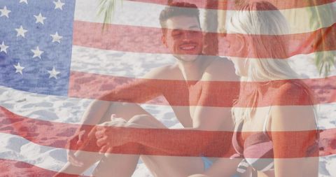 USA Flag Overlay on Couple Relaxing at Beach
