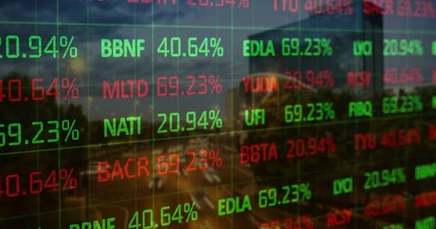 Transparent led stock ticker showing green and red percentages over urban glass facade