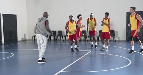 Dynamic basketball team training session with coach guidance