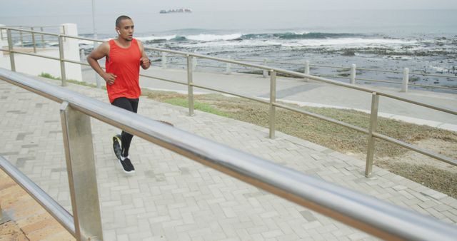 Young Man Running on Coastal Path in Red Tank Top - Download Free Stock Images Pikwizard.com