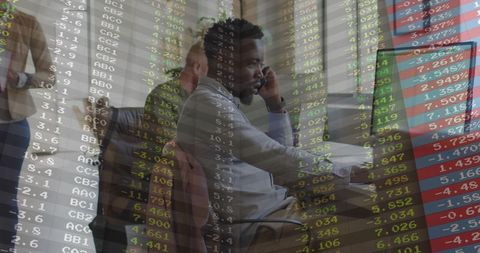 Businessman communicating with technology amid stock market data