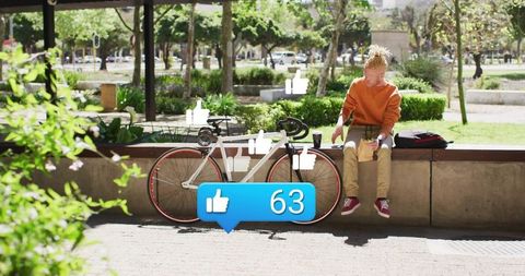 Young man sitting on plaza wall with bicycle and social likes badge for urban lifestyle