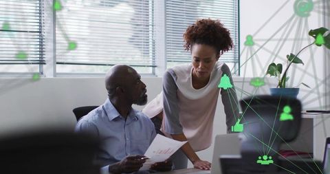 Business Colleagues Analyzing Data and Collaborating on Laptop