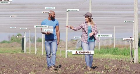 Tech-savvy farmers walking through sustainable farm