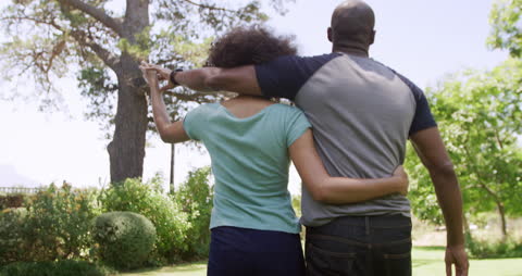 Couple Walking and Embracing in Sunny garden