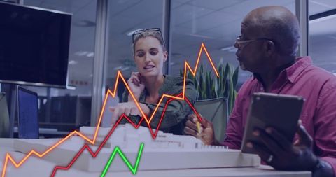 Business people analyzing data on laptop with growth charts