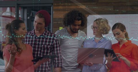 Diverse Team Collaborating in Modern Office with Digital Graphs