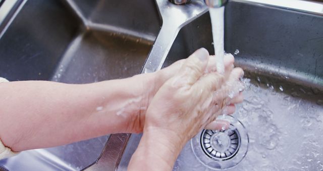 Hands washing under running water at kitchen sink - Download Free Stock Images Pikwizard.com