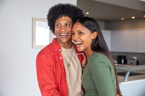Happy Couple Embracing in Modern Home Kitchen