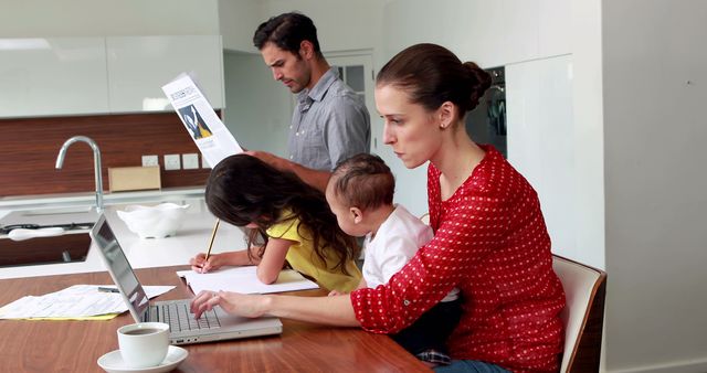 Family Multitasking at Kitchen Counter with Laptop and Newspapers - Download Free Stock Images Pikwizard.com