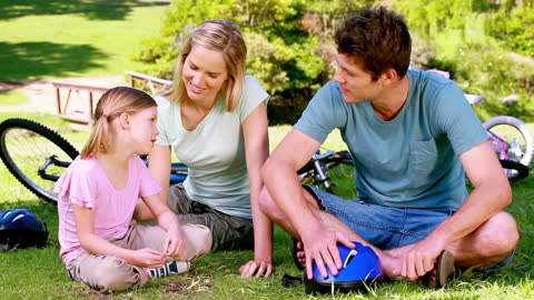 Family Relaxing in Park With Bicycles