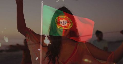Woman Celebrating at Beach Sunset with Portuguese Flag