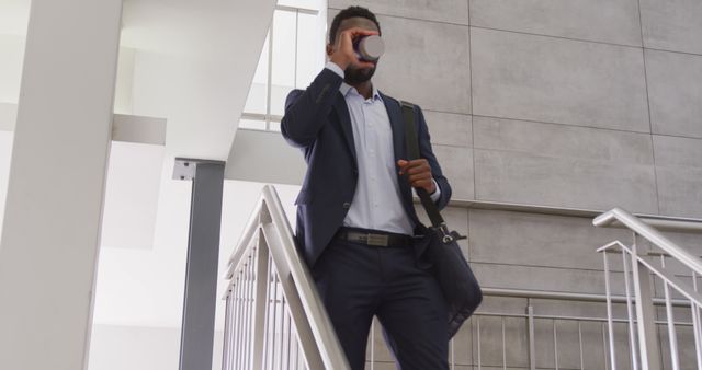 Businessman Drinking Coffee While Walking Downstairs - Download Free Stock Images Pikwizard.com