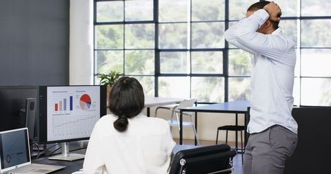 Multiracial Business Professionals Reviewing Data in Modern Office