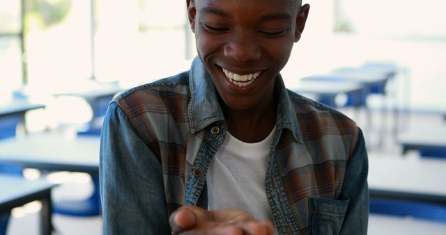 Young Man Smiling with Joy in Classroom - Download Free Stock Images Pikwizard.com