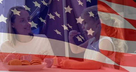 Mother and daughter enjoying pretend tea party with usa flag overlay