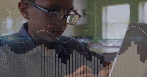 Young student studying with laptop and analytics hud overlay, glasses reflecting screen
