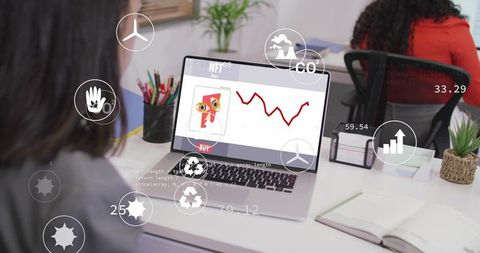 Displaying NFT Sales Chart and Buy Button on Laptop at Coworking Desk with Data Overlays