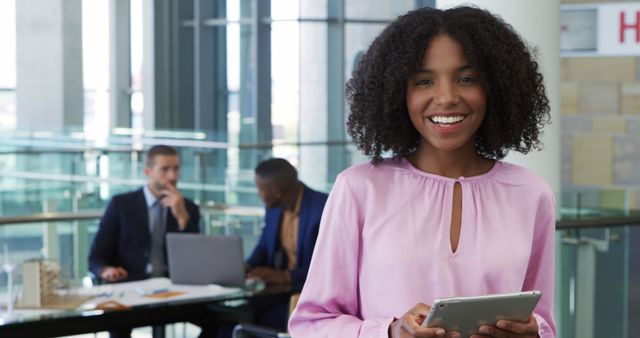Smiling African American Businesswoman Holding Tablet in Modern Office - Download Free Stock Images Pikwizard.com