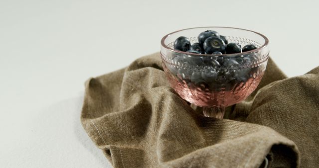 Fresh Blueberries in Vintage Pink Glass Bowl on Brown Fabric - Download Free Stock Images Pikwizard.com