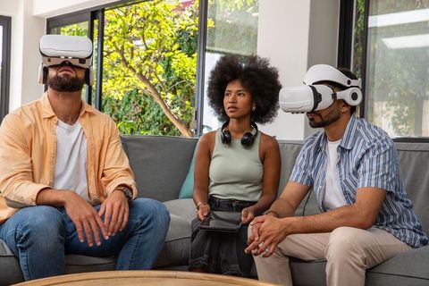 Friends Experiencing Virtual Reality with Headsets in Modern Living Room