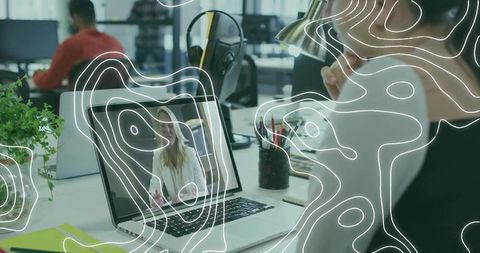 Remote meeting in modern open-plan office woman watching laptop during video conference