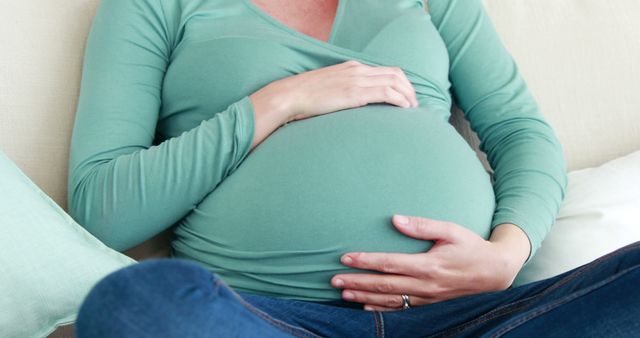 Pregnant Woman Holding Belly in Relaxed Pose - Download Free Stock Images Pikwizard.com