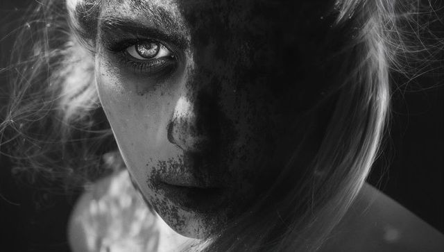 Dramatic Monochrome Portrait of Female Face with Textured Lighting