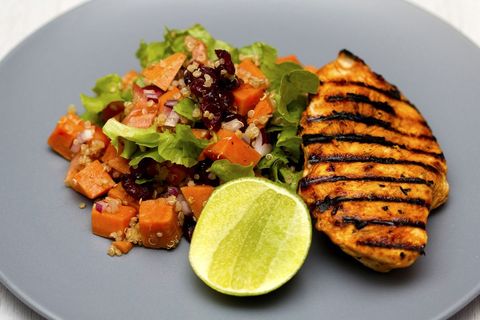 Grilled chicken breast featuring sweet potato quinoa salad, mixed greens and lime