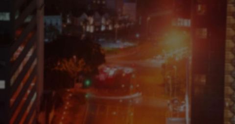 Urban Nightscape with Light Trails in Motion at Downtown Intersection