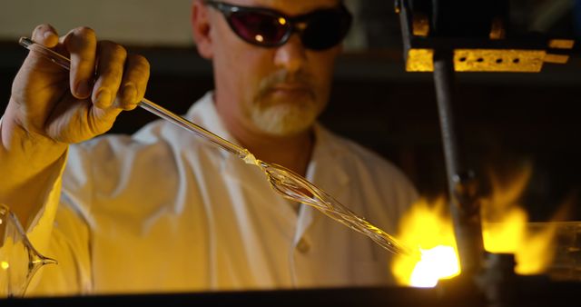 Glassblower Shaping Molten Glass Under Intense Flame - Download Free Stock Images Pikwizard.com