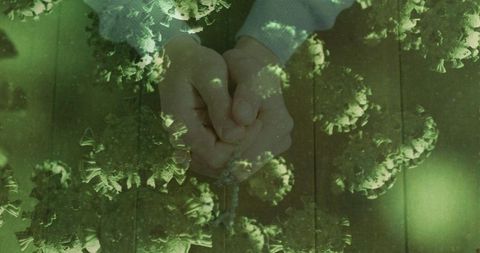 Hands clasped amidst virus imagery symbolizing unity and resilience