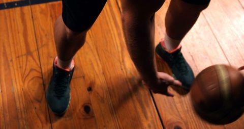 Action Shot of Athlete Dribbling Basketball on Gym Court