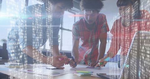 Diverse Team Collaborating on Innovative Project with Data Overlay