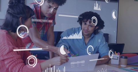 Team collaborating over laptop while analyzing interactive dashboards, charts and analytics