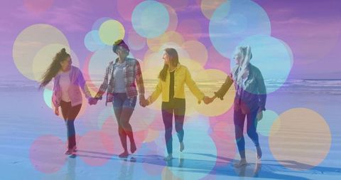 Four women walking hand in hand on beach with pastel bokeh overlays and reflections
